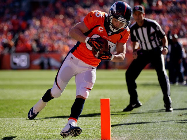 Wide receiver Wes Welker #83 of the Denver Broncos tip-toes into the end zone for a touchdown after making a reception during the first quarter against the Washington Redskins at Sports Authority Field Field at Mile High on October 27, 2013 