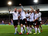 Fulham's Dimitar Berbatov celebrates with team mates after scoring his team's third goal against Crystal Palace on October 21, 2013