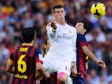 Gareth Bale of Real Madrid CF duels for the ball with Sergio Busquets of FC Barcelona during the La Liga match on October 26, 2013