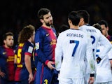 Gerard Pique and Cristiano Ronaldo exchange views during the Copa del Rey semi-final in February 2013.