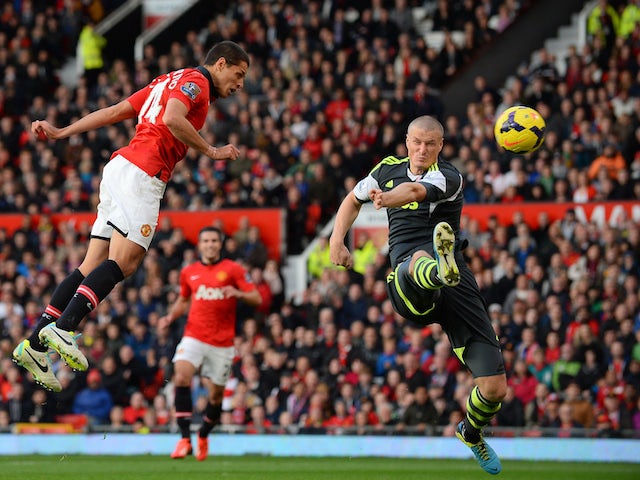 Manchester United's Mexican forward Javier Hernandez scores the third goal during the English Premier League football match against Stoke City on October 26, 2013