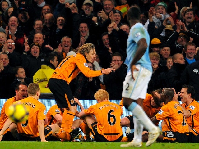 Hull City's Jimmy Bullard celebrates his goal at Manchester City by mocking an on-pitch team talk made by Phil Brown on November 28, 2009