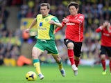 Jonny Howson of Norwich City in action with Kim Bo-Kyung of Cardiff City during the Barclays Premier League match between Norwich City v Cardiff City on October 26, 2013