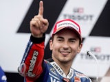 Jorge Lorenzo of Spain and Yamaha Factory Racing celebrates victory under the podium at the end of the MotoGP race ahead of the Australian MotoGP on October 20, 2013
