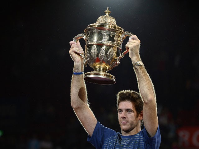 Argentina's Juan Martin Del Potro raises his trophy after winning the Swiss Indoors ATP tennis tournament final match against Switzerland's Roger Federer in Basel on October 27, 2013