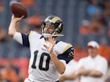 Quarterback Kellen Clemens #10 of the St. Louis Rams warms up against the Denver Broncos at Sports Authority Field at Mile High on August 24, 2013