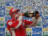Kimi Raikkonen of Finland and Ferrari celebrates on the podium after winning the race and the F1 World Championship at the Brazilian Grand Prix on October 21, 2007