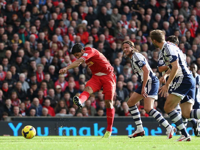 Luis Suarez of Liverpool scores the opening goal during the Barclays Premier League match between Liverpool and West Bromwich Albion at Anfield on October 26, 2013