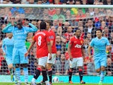 Mario Balotelli celebrates scoring in the Manchester derby at Old Trafford on October 23, 2011.