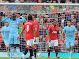 Mario Balotelli celebrates scoring in the Manchester derby at Old Trafford on October 23, 2011.