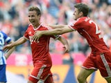 Bayern's Mario Goetze celebrates with team mate Thomas Mueller after scoring his team's third goal against Hertha Berlin on October 26, 2013