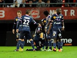 Evian's Moudou Sougou celebrates with teammates after scoring a goal during the French L1 football match Valenciennes vs Evian TG at the Stade Du Hainaut in Valenciennes on October 26, 2013