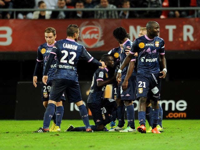Evian's Moudou Sougou celebrates with teammates after scoring a goal during the French L1 football match Valenciennes vs Evian TG at the Stade Du Hainaut in Valenciennes on October 26, 2013