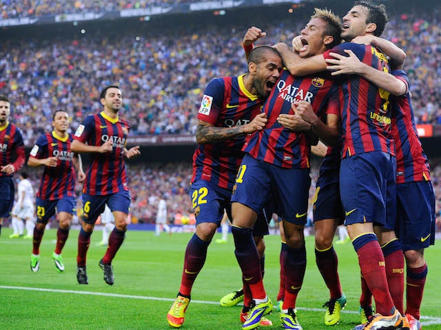 Neymar celebrates with his team-mates after scoring the opening goal during the La Liga match between FC Barcelona and Real Madrid CF at Camp Nou on October 26, 2013