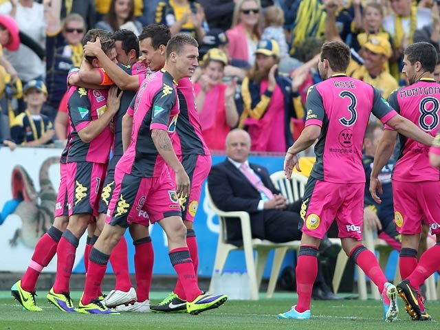 Central Coast Mariners' Nicholas Fitzgerald is congratulated by team mates after scoring the opening goal against Adelaide United on October 26, 2013