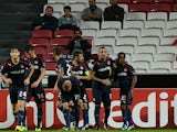 Olympiacos' players celebrate their first goal during the UEFA Champions League group C football match SL Benfica vs Olympiacos FC at Luz Stadium in Lisbon on October 23, 2013
