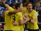 Dortmund's Pierre-Emerick Aubameyang is congratulated by team mates after scoring the opening goal against Schalke on October 26, 2013