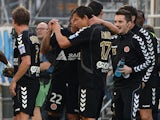 Reims' players celebrate after scoring a goal during the French L1 football match between Marseille and Reims at the Velodrome stadium in Marseille on October 26, 2013