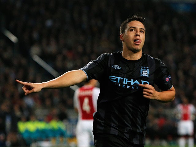 Samir Nasri of Manchester City celebrates scoring the first goal of the game during the Group D UEFA Champions League match between AFC Ajax and Manchester City FC at Amsterdam ArenA on October 24, 2012 