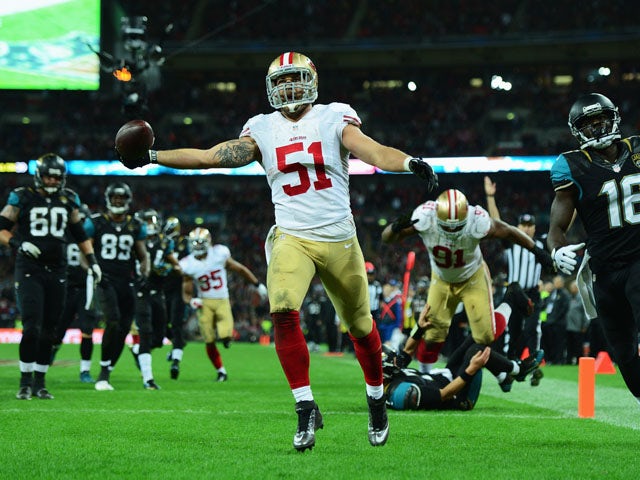 Dan Skuta of the San Francisco 49ers scores a touchdown during the NFL International Series game between San Francisco 49ers and Jacksonville Jaguars at Wembley Stadium on October 27, 2013
