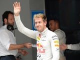Sebastian Vettel waves to the crowd after qualifying first during the Formula One India Grand Prix on October 26, 2013