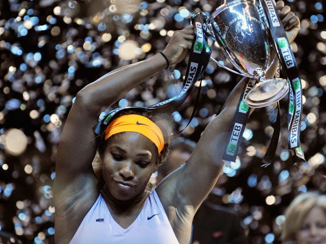 Serena Williams of the US celebrates with her trophy after winning the WTA Championships final tennis match against China's Li Na on October 27, 2013