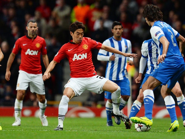 Manchester United's Japanese midfielder Shinji Kagawa vies with Real Sociedad's defender Carlos Martinez during the UEFA Champions League football match on October 23, 2013