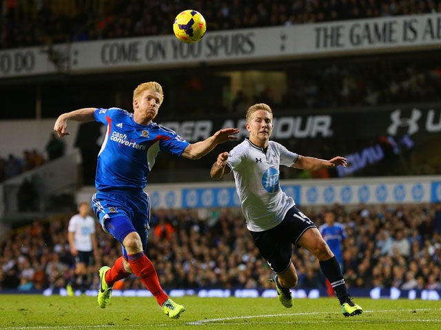 Lewis Holtby of Spurs clashes with Paul McShane of Hull City during the Barclays Premier League match between Tottenham Hotspur and Hull City at White Hart Lane on October 27, 2013