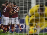 AS Roma's US midfielder Michael Bradley celebrates with teammates after scoring during the Serie A football match Udinese vs AS Roma at 'Stadio Friuli' in Udine on October 27, 2013
