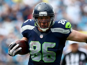 Zach Miller of the Seattle Seahawks runs with the ball as Jon Beason of the Carolina Panthers tries to make a tackle during their game on September 8, 2013