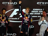 Red Bull Racing's drivers German Sebastian Vettel and Australian Mark Webber and Mercedes' German driver Niko Rosberg poses after winning the Abu Dhabi Formula One Grand Prix on November 3, 2013