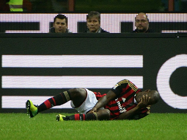 AC Milan's forward Mario Balotelli falls down before leaving the pitch on an injury during the Italian serie A football match AC Milan vs Fiorentina, on November 2, 2013