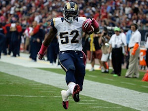 Alec Ogletree of the St. Louis Rams returns an interception 98 yards for a touchdown in the third quarter against the Houston Texans at Reliant Stadium on October 13, 2013