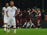 Torino's midfielder Alessio Cerci celebrates with teammates after scoring during the Italian Serie A football match Torino vs AS Roma at 'Olympic Stadium' in Turin on November 3, 2013