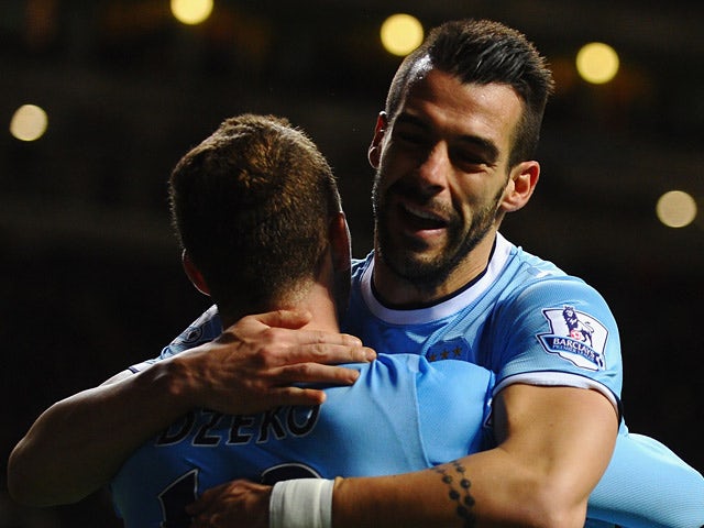 Man City's Alvaro Negredo celebrates with teammate Edin Dzeko after scoring the opening goal in extra time against Newcastle during their Capital One Cup Fourth Round match on October 30, 2013