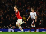 Aaron Ramsey of Arsenal celebrates scoring their second goal during the Barclays Premier League match between Arsenal and Liverpool at Emirates Stadium on November 2, 2013
