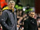 Arsenal's manager Arsene Wenger and his Chelsea counterpart Jose Mourinho watch their teams during their premiership match at Highbury in north London, 18 December 2005