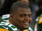 B.J. Raji #90 of the Green Bay Packers watches from the bench as his teammates take on the Arizona Cardinals at Lambeau Field on August 9, 2013