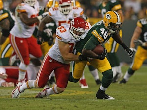 Brandon Bostick #48 of the Green Bay Packers is tackled by Cory Greenwood #93 of the Kansas City Chiefs during a preseason game at Lambeau Field on August 30, 2012