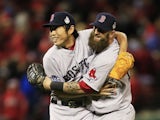 Koji Uehara #19 of the Boston Red Sox celebrates with teammate Mike Napoli #12 after throwing out Kolten Wong #16 of the St. Louis Cardinals to win Game Four of the 2013 World Series at Busch Stadium on October 27, 2013