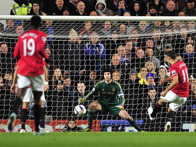 Manchester United's Welsh midfielder Ryan Giggs shoots to score the opening goal as Chelsea's Czech goalkeeper Petr Cech looks on during the English League Cup Fourth Round football match between Chelsea and Manchester United at Stamford Bridge in London,