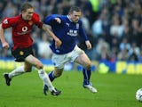 Involved in an early battle with his future teammate Wayne Rooney, then of Everton in 2004.