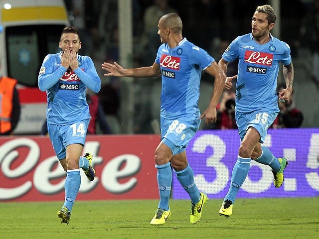 Napoli's Dries Mertens celebrates with teammates after scoring his team's second goal against Fiorentina on October 30, 2013