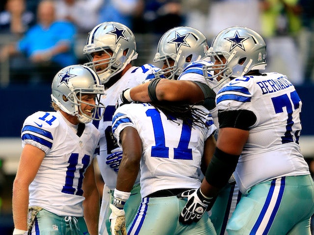 Wide receiver Dwayne Harris of the Dallas Cowboys is congratulated by teammates after scoring a touchdown late in the 4th quarter during the game against the Minnesota Vikings on November 3, 2013
