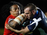Fuifui Moimoi of Tonga is tackled by Dael Ferguson of Scotland during the Rugby League World Cup Group C match between Tonga and Scotland on October 29, 2013