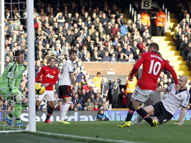 Manchester United's English striker Wayne Rooney scores the opening goal during the English Premier League football match between Fulham and Manchester United at Craven Cottage in London on November 2, 2013