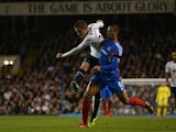 Tottenham's Gylfi Sigurdsson beats Hull's Curtis Davies to score the opening goal in their Capital One Cup Fourth Round match on October 30, 2013