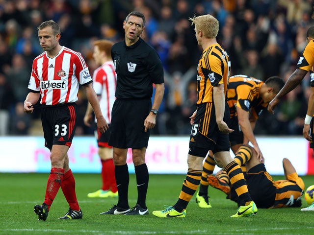 Lee Cattermole of Sunderland is sent off with a red card by referee Andre Marriner after a foul on Ahmed Elmohamady (down) of Hull during the Barclays Premier League match between Hull City and Sunderland at KC Stadium on November 2, 2013