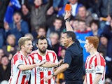 Andrea Dossena of Sunderland is sent off with a red card by referee Andre Marriner as team-mate Sebastian Larsson protests during the Barclays Premier League match between Hull City and Sunderland at KC Stadium on November 2, 2013