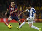 Espanyol's Juan Rafael Fuentes and Barcelona's Lionel Messi battle for the ball on November 1, 2013